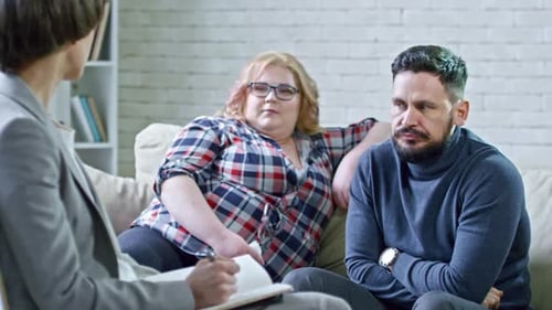 Couple Talking With Therapist on Couch