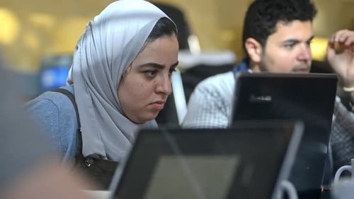 Young Multi-ethnic People Are Using Laptops While Studying at Table in University Room Irrl.