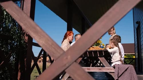 Family Dinner in the Garden on the Terrace on a Rustic Wooden Table the Concept of Eating Healthy