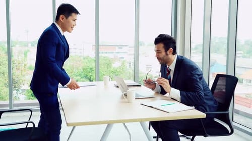 Businessmen Handshake Agreement in Modern Office Setting