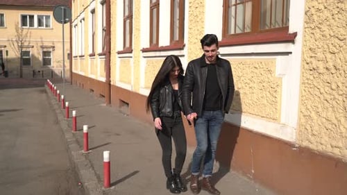 Couple walking on a street with old buildings