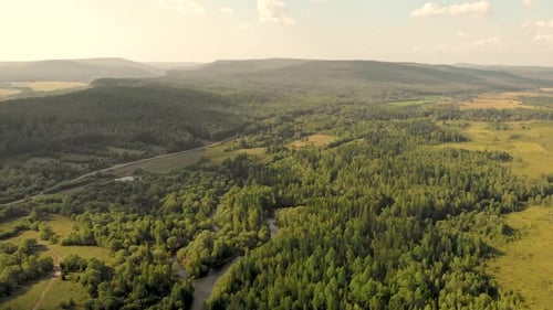 Aerial View From Drone of Rural Village Among Fields, Forests, River and Hills.