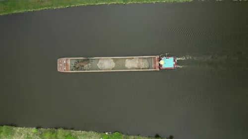 Aerial View of Large Cargo Barge Moving Along the River