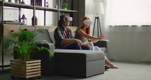 Couple Wearing VR Headsets at Home