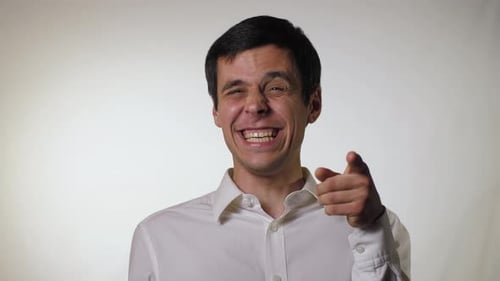 Cheerful Man Laughing and Pointing at Camera