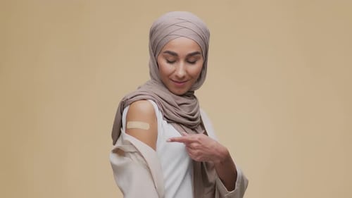 Woman with Bandage Gives Thumbs Up