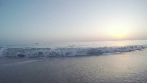 Turquoise Sea Water Waves and Sand Beach and Blue Sky