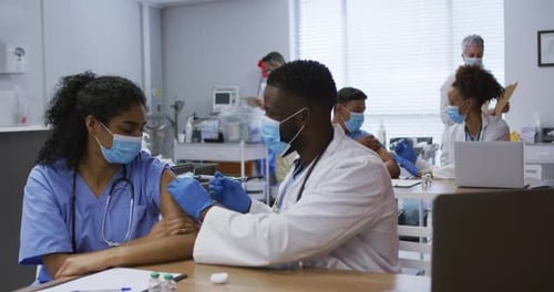 Doctor Giving Injection to Woman in Hospital Setting