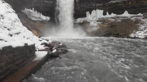Showing a waterfall and river from a low angle during a cloudy winter day