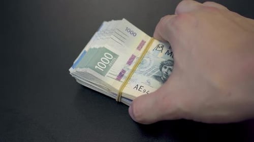 Stack of 1000 Mexican Peso Banknotes on Table
