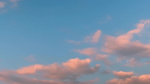 Pink Clouds Moving Slowly in Blue Sky