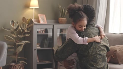 Loving Child Hugging Parent in Military Uniform