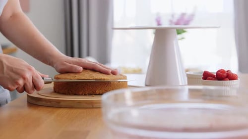 Woman Prepares Cake at Home in Bright Kitchen