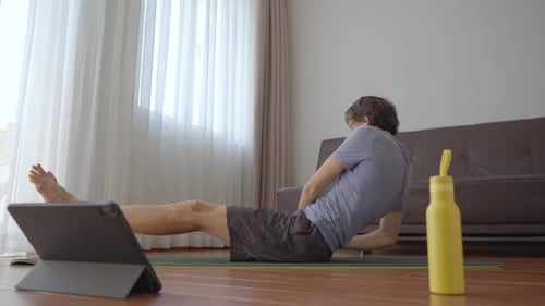 Man Doing Core Workout At Home