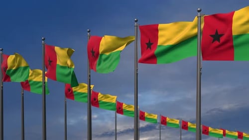 Waving Guinea-Bissau Flags Against Blue Sky