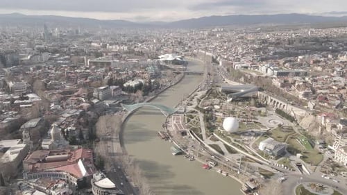 Aerial view of Tbilisi city central park and Bridge of Peace. Beautiful cityscape of old Tbilisi