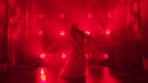 Woman Dancing on Stage in Red Light