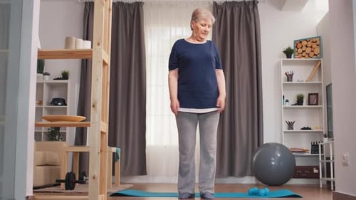 Senior Woman Exercising on Yoga Mat at Home