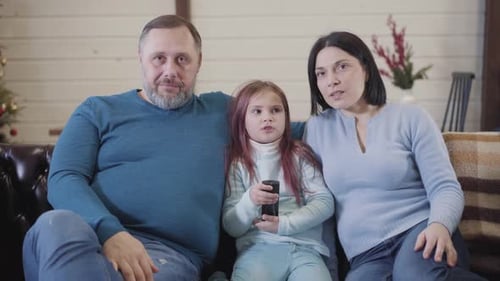 Family Togetherness At Home on Couch Smiling