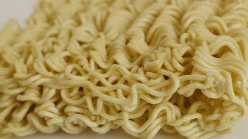 Tasty Chinese noodles close-up 4K 2160p 30fps UltraHD panning footage - Instant staple food block