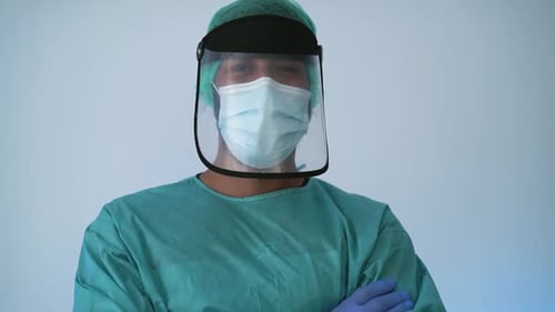Medical Worker in Protective Gear with Arms Crossed