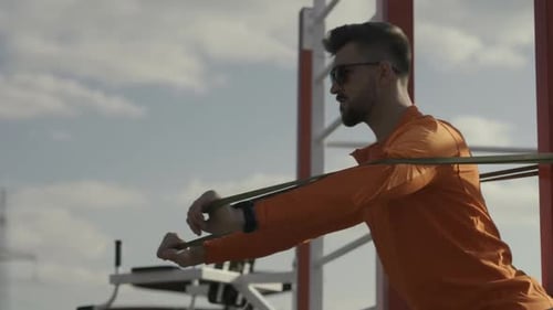 Man Exercising with Resistance Band Outdoors