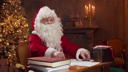 Stressed Santa Reading Letters at Christmas Desk