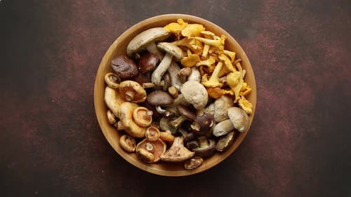 Raw and Fresh Forest Various Mushrooms in Bowl Standing on Rusty Table