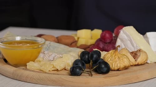 Close Up of Gourmet Cheese Board with Honey