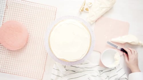Flat lay. Assembling pink and purple cake layer to make unicorn cake for little girl's birthday part
