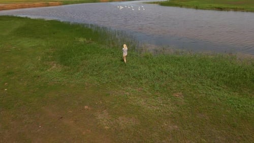 Woman Photographing Lake Landscape From Above