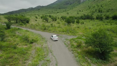 Top view of car traveling in mountain valley