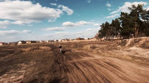 Motocross Riders on Dirt Track in Rural Setting