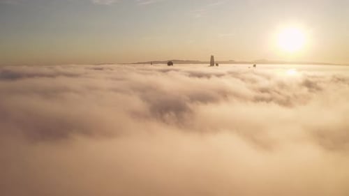 Aerial Cityscape Over Fog at Golden Hour Sunrise