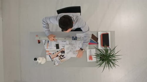 Architect Is Working on Plan of Building with a Ruler