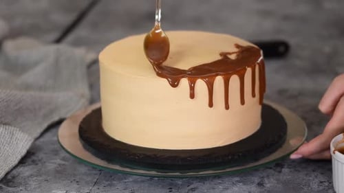 Caramel Being Drizzled onto Round Frosted Cake