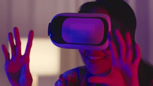 Woman Using VR Headset at Home at Night