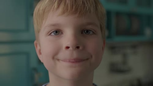 Boy Smiling Cheerfully in Close Up Indoors