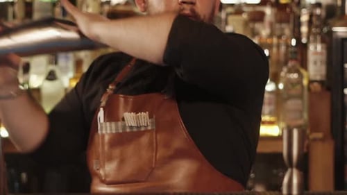 Close Up Shot of the Barman Hands He Shakes Shaker with Ingredients for Cocktail