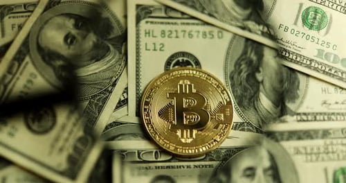 Bitcoin Coin on Top of Dollar Bills