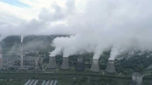 Aerial Drone View of Smoking Pipes and Cooling Towers of Coal Thermal Power Plant