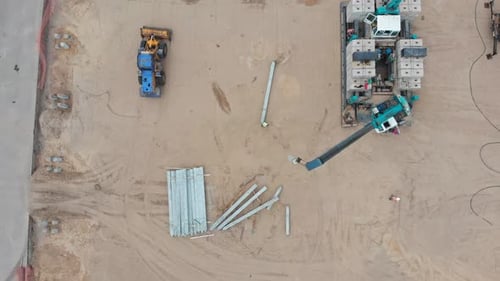 Lifting Crane on the Construction Site Lifts Concrete Blocks