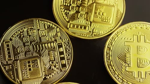 Rotating shot of Bitcoins (digital cryptocurrency) - BITCOIN