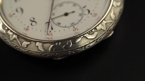 Detailed Silver Pocket Watch Carvings on Black