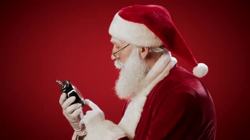 Santa Claus Checking the Time with Alarm Clock