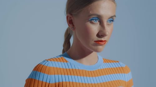 Woman Posing with Bold Makeup and Fashionable Top