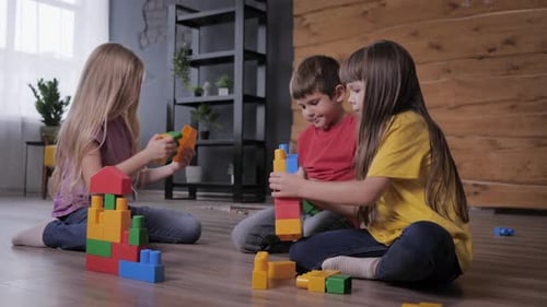Children Building with Toy Blocks Together at Home