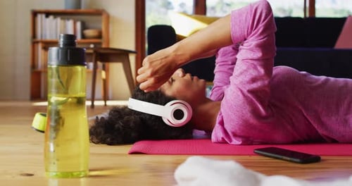 Woman Lying on Yoga Mat After Workout