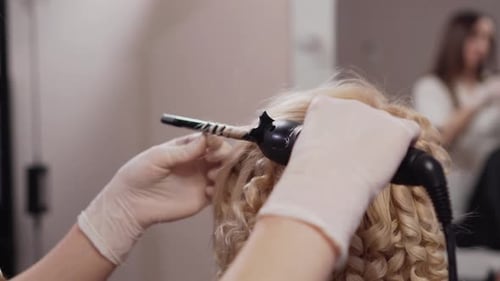 The Hairdresser Makes Afrocurls to the Client