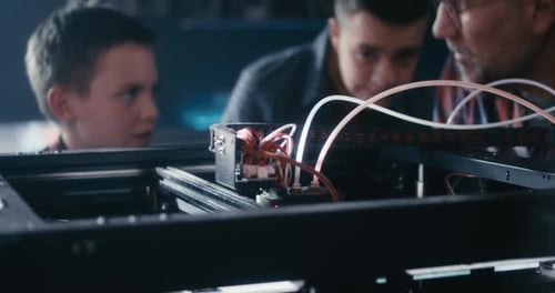 Teacher and Students Using 3D Printer